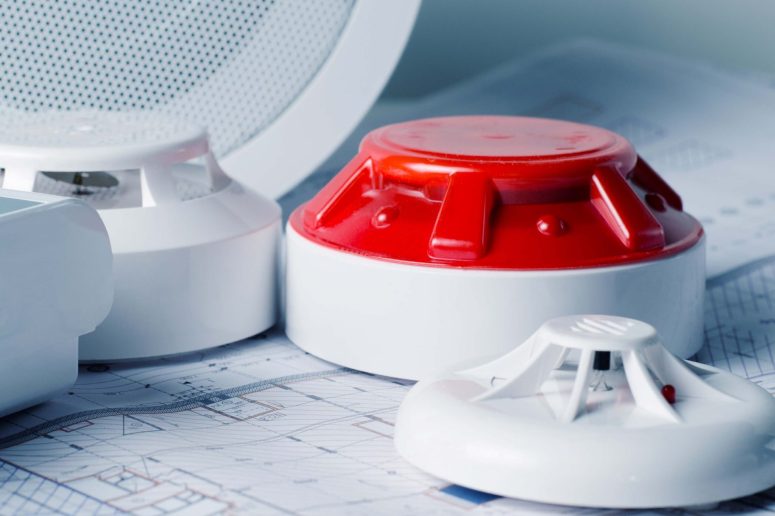 Rivo Security and Monitoring officer monitoring fire and intruder alarm systems in an industrial warehouse environment.