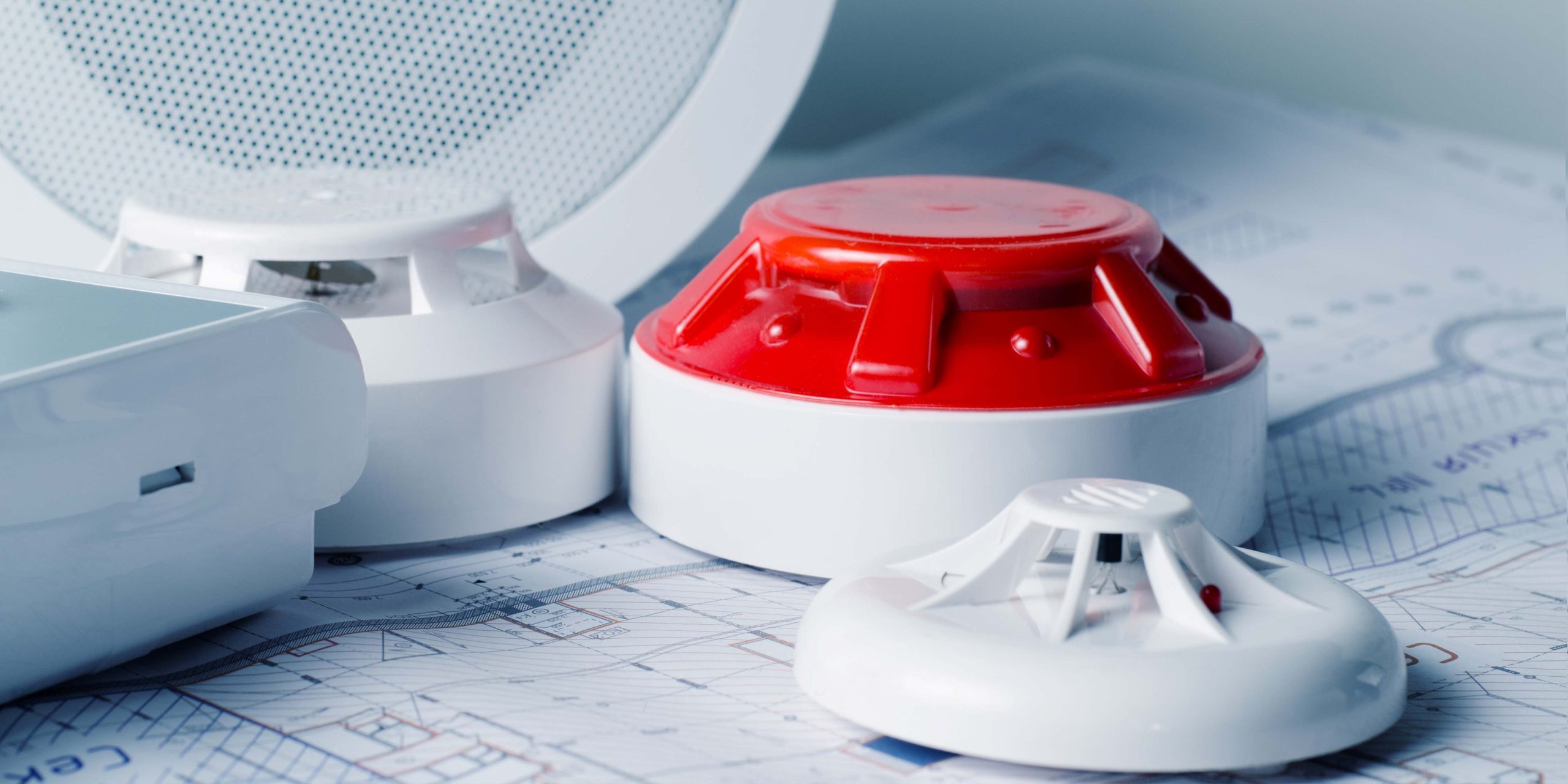 Rivo Security and Monitoring officer monitoring fire and intruder alarm systems in an industrial warehouse environment.